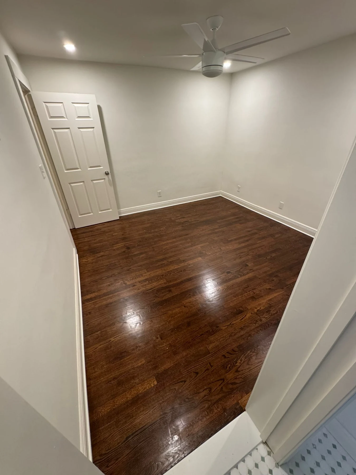 Empty room with white walls and wood floor